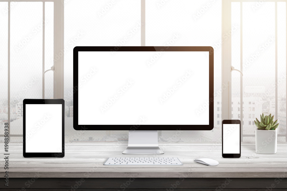 Responsive web site promotion. Isolated blank computer, tablet and smart phone display. Window and sun light in background. Responsive web site promotion. Isolated blank computer, tablet and smart phone display. Window and sun light in background.