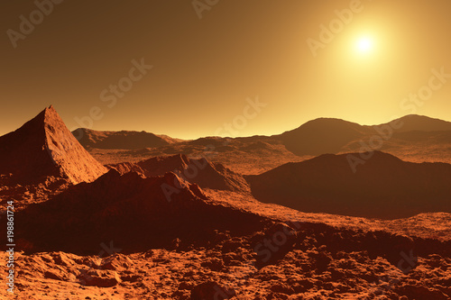Mars - red planet - landscape with huge crater from impact and mountains in the distance during sunrise or sunset