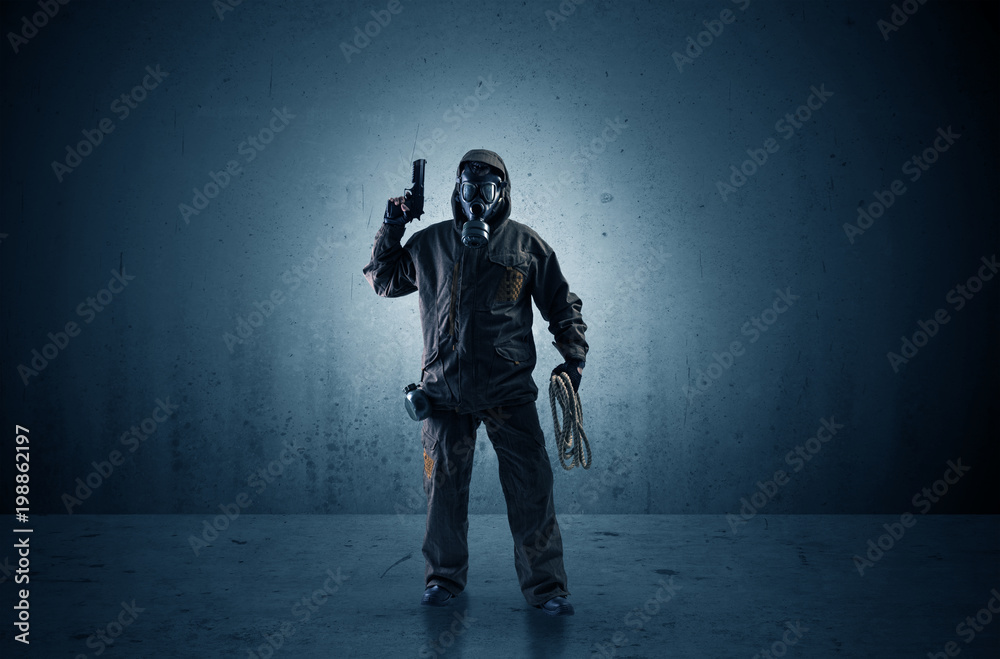 Fototapeta premium Bad agent in a dark room with arms on his hand and gas mask 