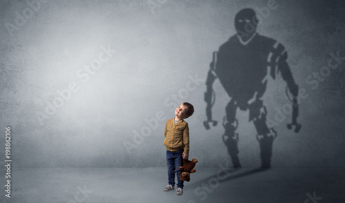 Little boy self image appear as a big robotman shadow on his background © ra2 studio
