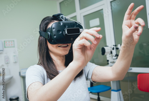 Eye treatment. Patient in virtual reality goggles. Checking the girl's vision with the help of virtual reality. photo