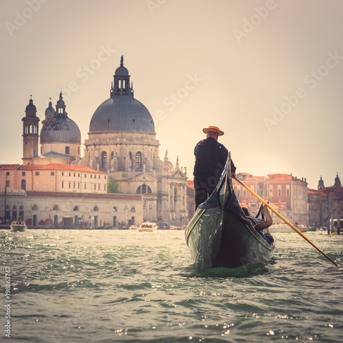 Gondolier in the Grand Canal of Venice, Italy