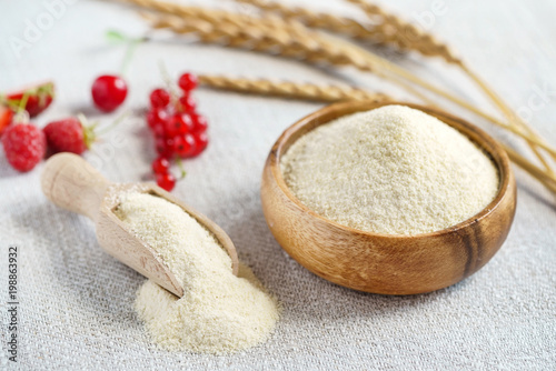 Raw unprepared semolina in bowl photo