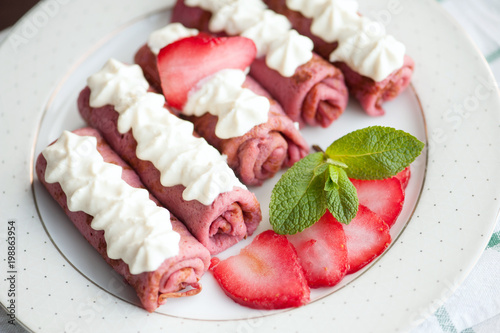 Pink pancakes with strawberries, five french style crepes