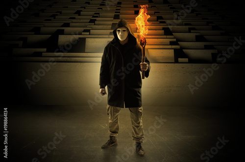 Tableau sur toile Ugly, aberrant man coming out from the labyrinth with burning flambeau on his ha