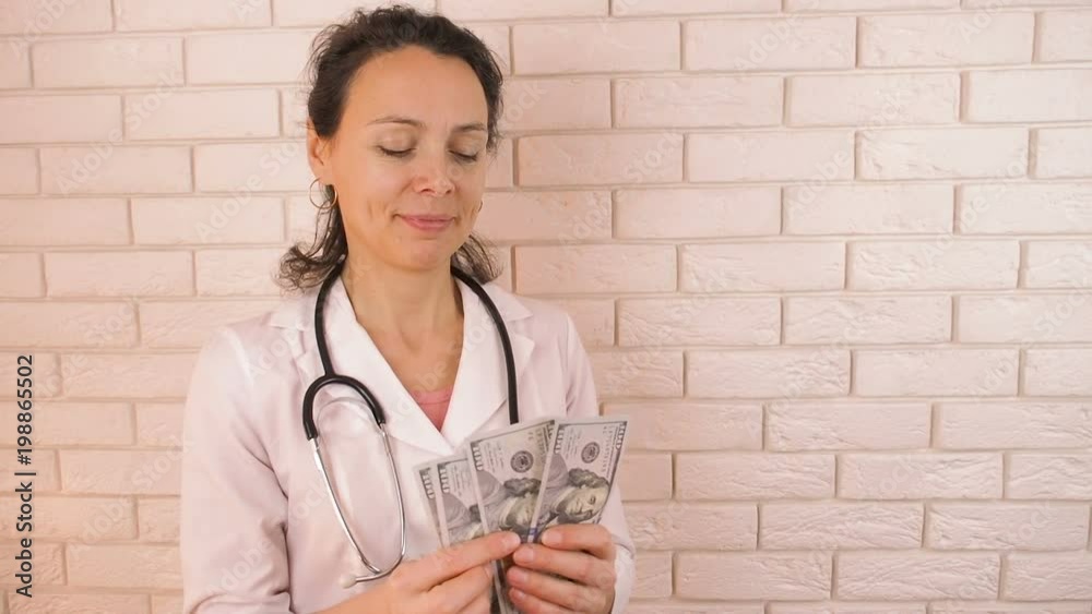Doctor with money. Woman doctor shows money. Doctor with money. Woman doctor shows money.