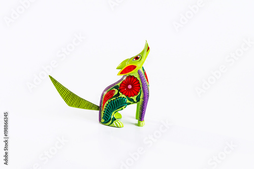 Mexican green and red alebrije from oaxaca isolated on white background. Profile