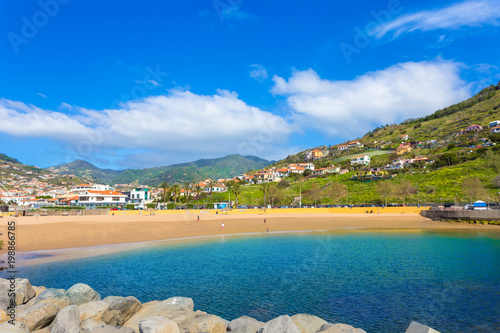 Obraz na płótnie Famous beach of Machico in summer holiday, with sunshine and blue water of the s