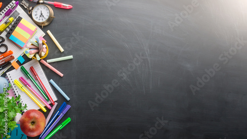 Banner Concept Back To School Alarm Clock Color Chalk Pencil Apple Notebook Stationery on Green Blackboard Background. Design Copy Space Supplies Top View Flat Lay