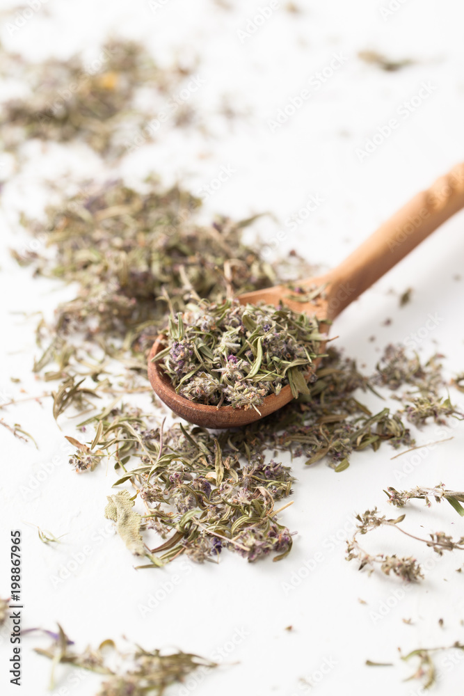 The dried herb thyme on a white table The dried herb thyme on a white table