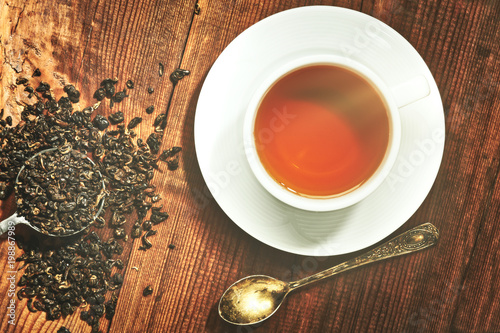 Closeup of cup of tea on vintage wooden background