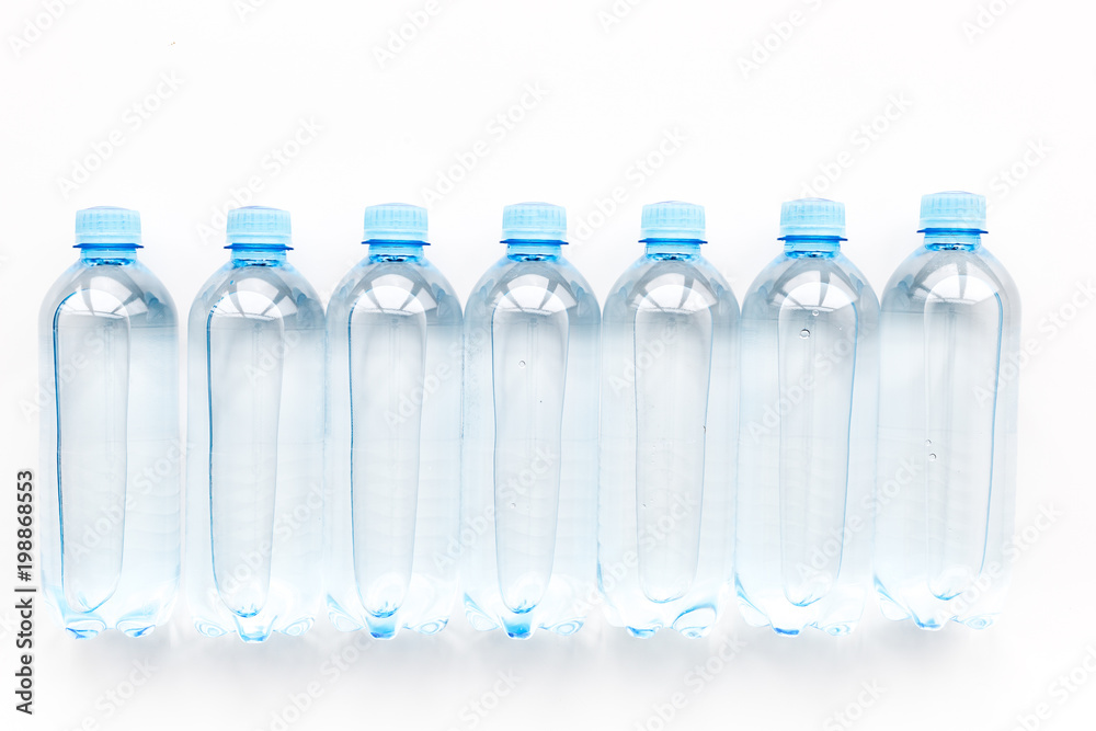 Drinking water in bottles on white background top view Drinking water in bottles on white background top view
