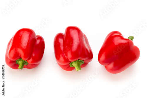 Red bell pepper with half and leaves isolated on white.