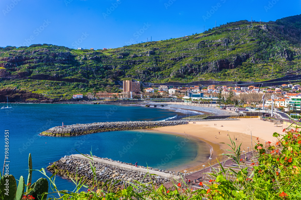 Beautiful landscape with Machico cityscape, coastline and the beach in a sunny day, in Madeira - Portugal