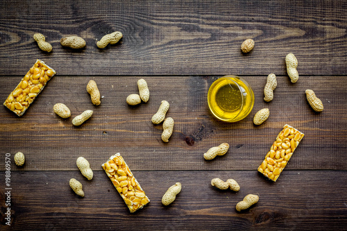 Energy protein snacks with peanuts on dark wooden background top view