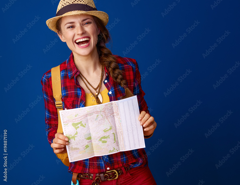 smiling fit traveller woman on blue background with map