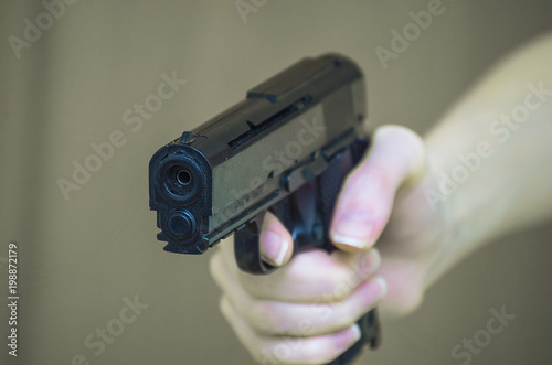 girl holding a gun close-up