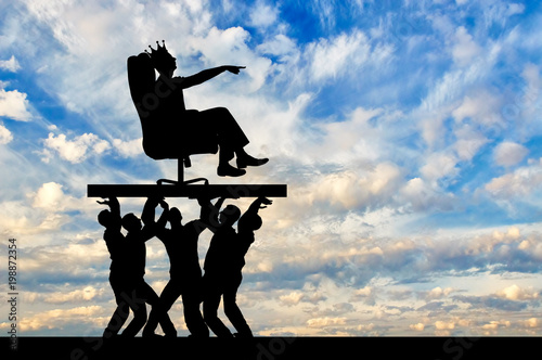 Fotografia Concept of a selfish man with a crown on his head sitting in a chair and his sub