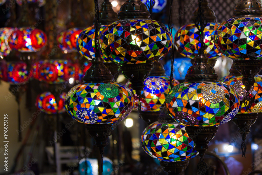 View of traditional bright decorative hanging Turkish lamps and colourful lights with vivid colours  in the Grand Bazaar. Istanbul. Turkey. Most popular souvenirs for tourists.