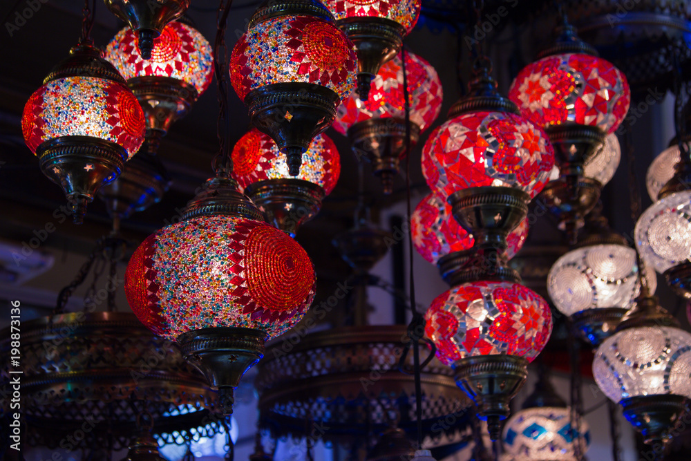 View of traditional bright decorative hanging Turkish lamps and colourful lights with vivid colours  in the Grand Bazaar. Istanbul. Turkey. Most popular souvenirs for tourists.