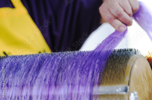 Felting wool. The step of combing the material in a special carding machine. photo