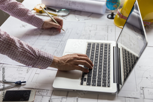 Asia Young woman engineer working on blueprint in office. asian women engineer working on architects project.  Young architect work project.
