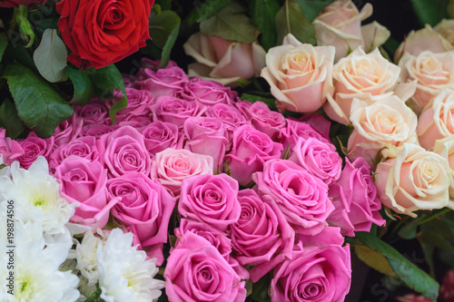A row of bouquets of roses and chrysanthemums in the market store