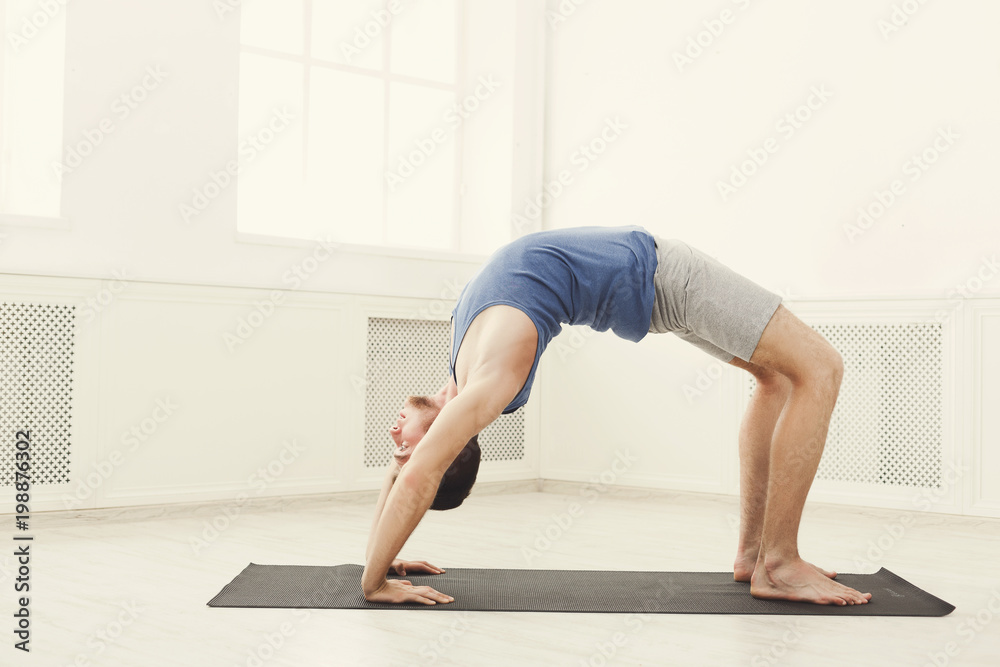 Man training yoga in table top pose.
