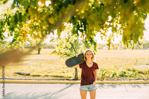 young girl riding a skateboard sunset, youth, shadower and freedom photo