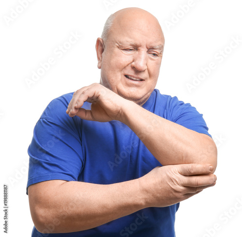 Senior man suffering from pain in elbow on white background