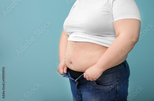 Overweight woman on color background