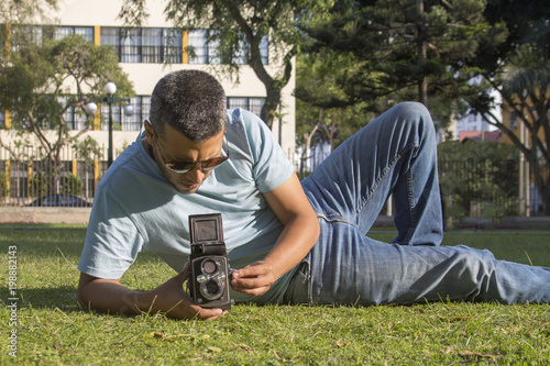 Man taking pictures with old camera