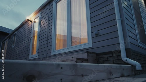 Modern static caravan. mobile House. evening time, in the windows light