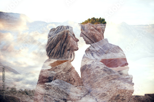 Double exposure man and woman couple hugging with mountains in background. Mountains inside couple in love. Lovers look at each other, tender feelings and love, superimposition of two frames photo