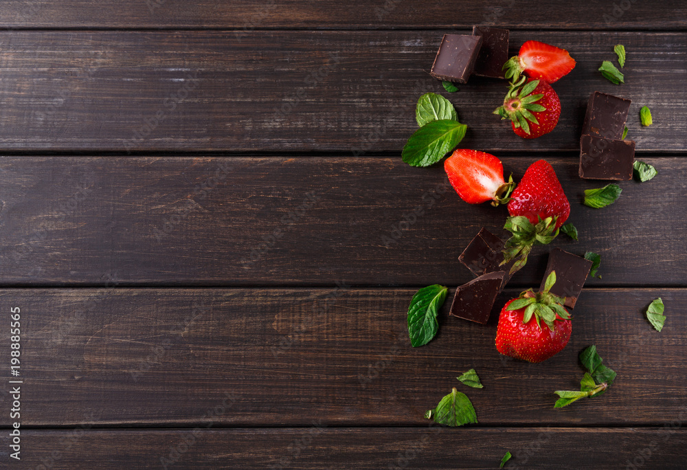Fresh strawberries with chocolate on rustic table