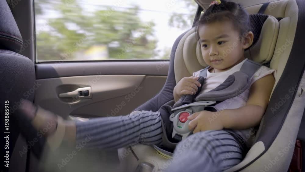Portrait of cute toddler asian girl sitting in car seat. Child transportation safety Portrait of cute toddler asian girl sitting in car seat. Child transportation safety