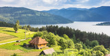 Panorama of a little house on the the shore of Lake Bicaz, Romania