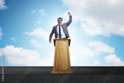Man businessman making speech at rostrum in business concept