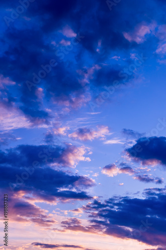 Vivid color clouds on sunset landscape. Blue sky with bright pink, yellow and purple