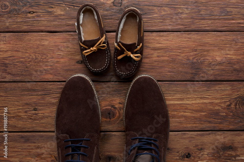 Male and child shoes on rustic wood background