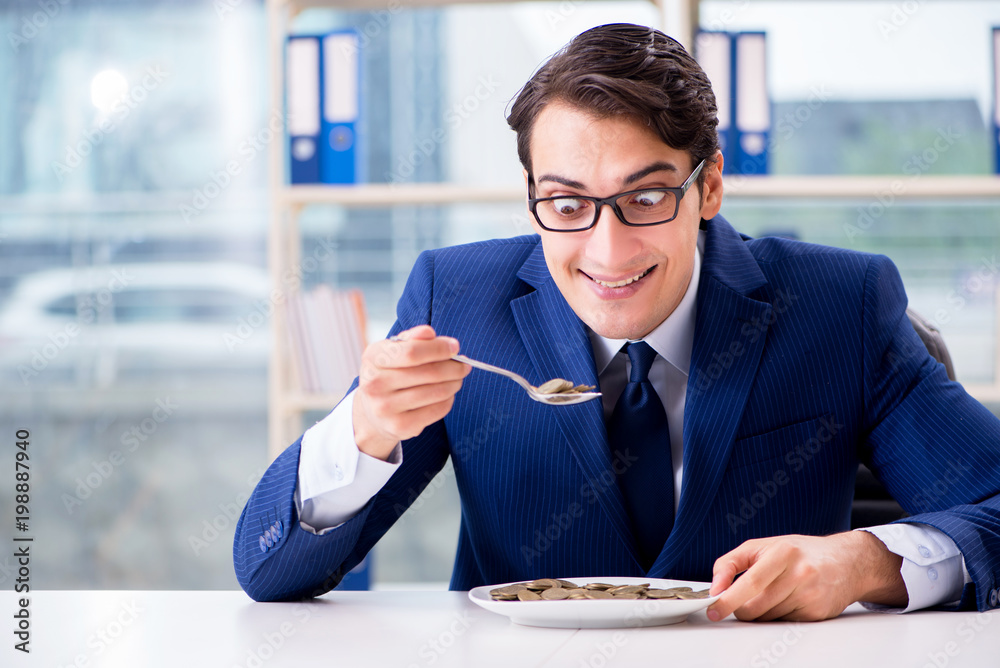 Funny businessman eating gold coins in office Stock Photo | Adobe Stock