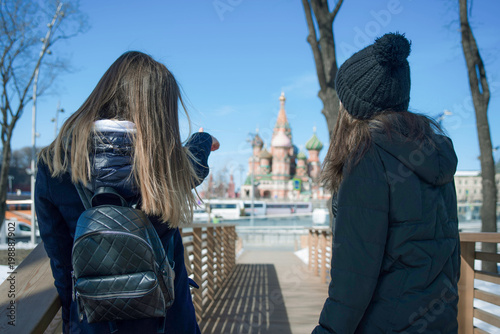 Two young girls are walking on Zaryadye park near Kremlin in Moscow, Russia