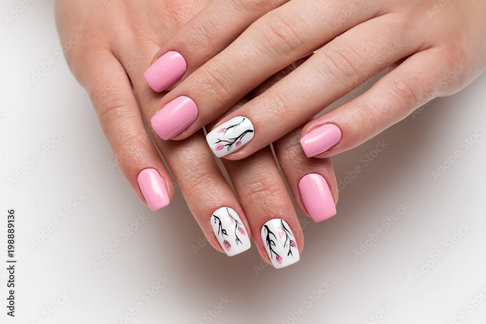 delicate pink manicure with spring flowers on short square nails on a white background - obrazy, fototapety, plakaty 
