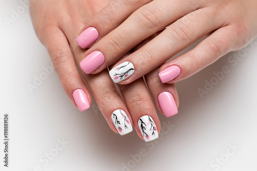 Tablou canvas delicate pink manicure with spring flowers on short square nails on a white back