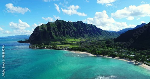 Aerial view flying towards lush jungle mountain landscape on the east side of Oahu in Hawaii 
