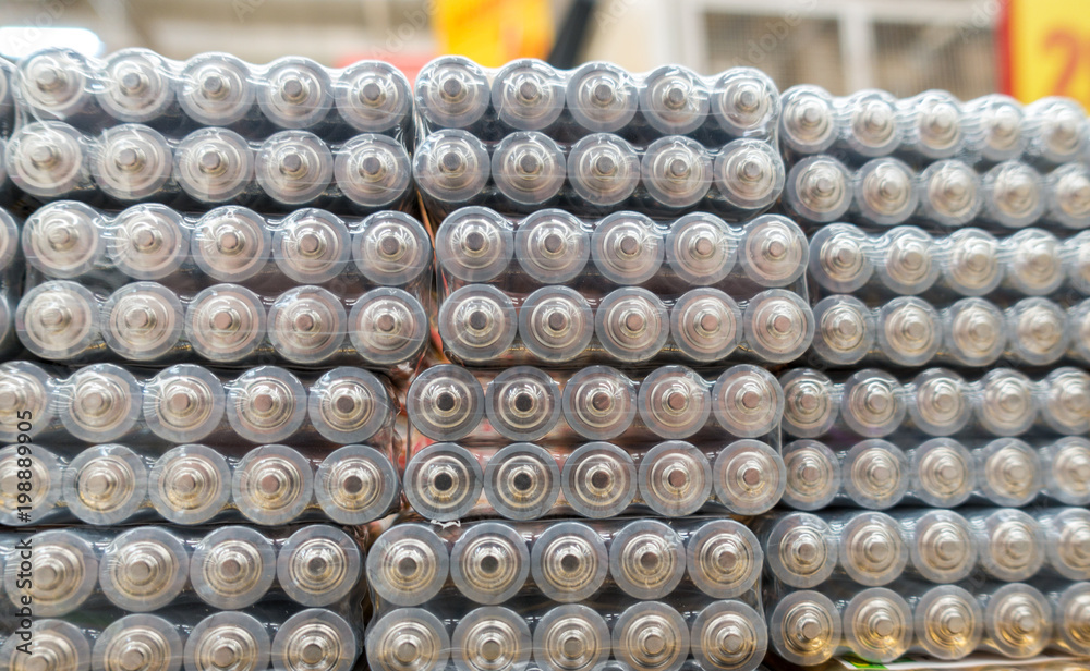 Electric batteries size AAA AA lot of gray in the package in the store. Shallow depth of field Electric batteries size AAA AA lot of gray in the package in the store. Shallow depth of field