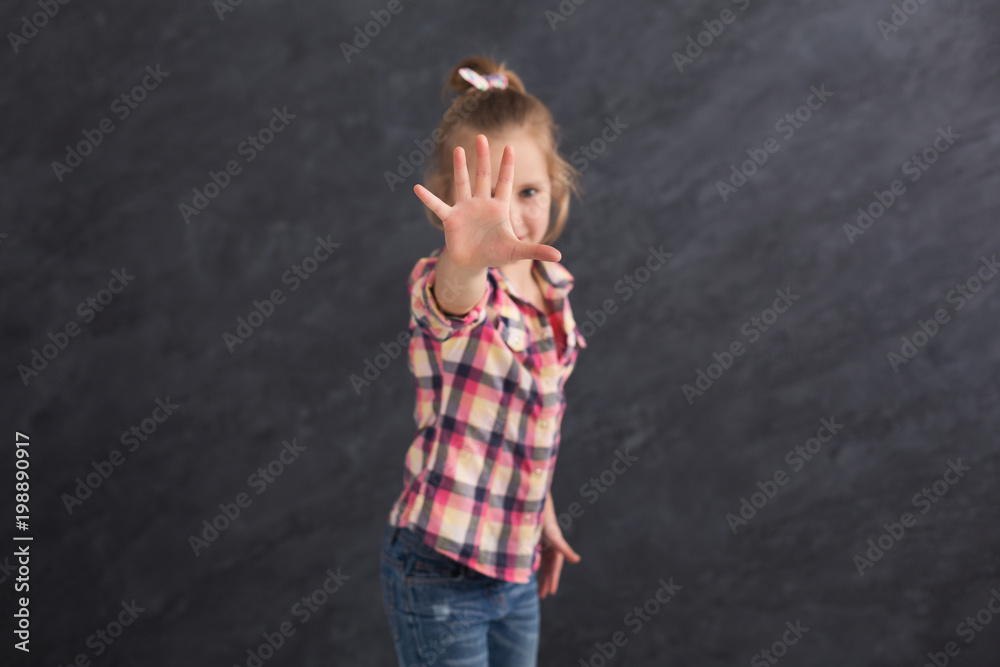 Little girl saying no, showing stop sign Little girl saying no, showing stop sign