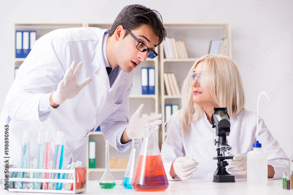 Two chemists having discussion in lab