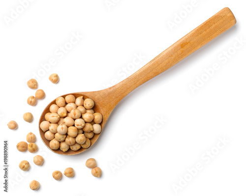 dried chickpeas in the wooden spoon, isolated on white, top view photo