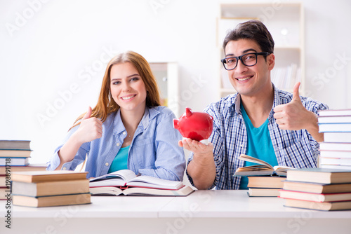 Two students checking savings to pay for education photo